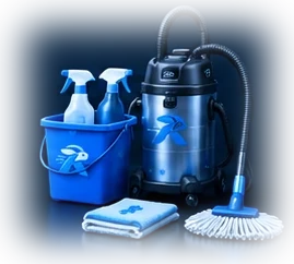 Cleaning bucket with spray bottles, a vacuum cleaner, a mop and folded cloths
